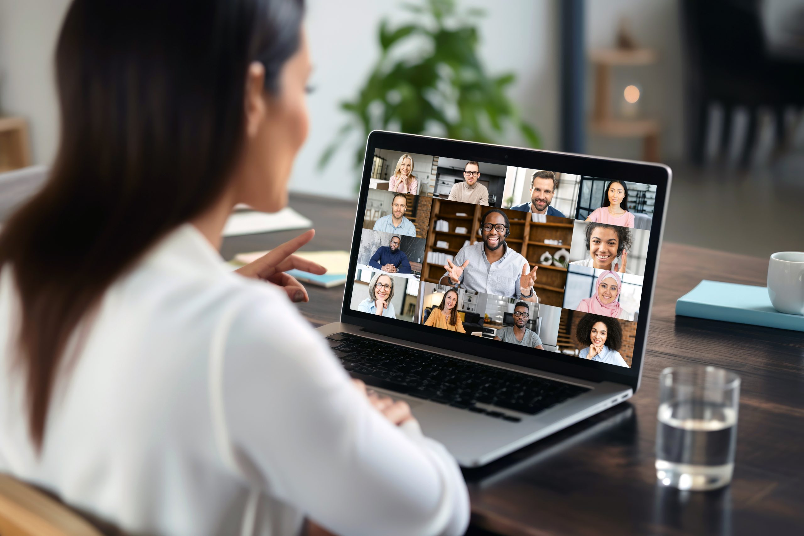 businesswoman having video conference call with colleagues. remote workers discussing work plans by video digital conference call on laptop.